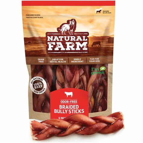 Braided bully sticks made from natural farm raw beef jerky, displayed on a wooden surface