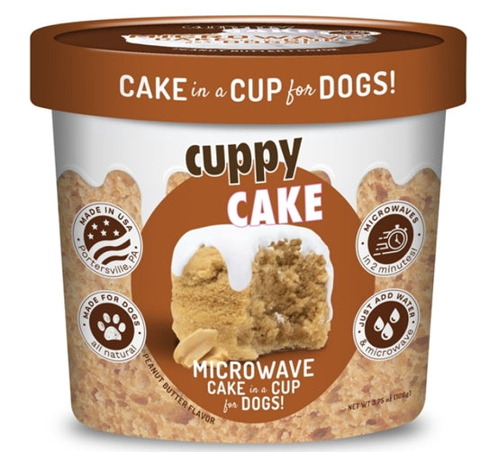 A cup of cake ice cream topped with a playful dog figurine, adding a whimsical touch to the dessert.
